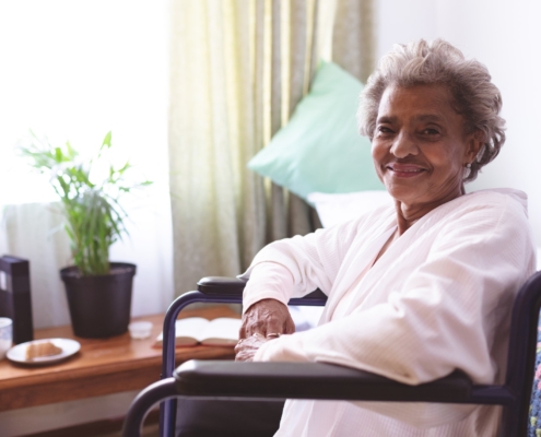 Senior woman sitting in wheelchair at nursing home